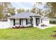 Inviting single-story home featuring lush landscaping, dark shutters, and a two-car garage at 1621 Crescent Rd, Longwood, FL 32750