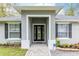 Inviting front entrance with a decorative door, brick walkway, and fresh landscaping at 1621 Crescent Rd, Longwood, FL 32750