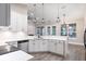Bright kitchen featuring white cabinets, stainless steel appliances, and pendant lighting at 1621 Crescent Rd, Longwood, FL 32750