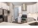 Modern kitchen featuring stainless steel appliances, white cabinets, and quartz countertops at 1621 Crescent Rd, Longwood, FL 32750