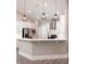 Bright kitchen featuring white cabinets, stainless steel appliances, and stylish pendant lighting at 1621 Crescent Rd, Longwood, FL 32750