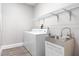 Bright laundry room features a washer, dryer, utility sink and storage shelf at 1621 Crescent Rd, Longwood, FL 32750