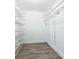 Spacious walk-in closet with white wire shelving and neutral walls, perfect for organizing clothes and accessories at 1621 Crescent Rd, Longwood, FL 32750