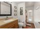 This bathroom is conveniently located with a door to the lanai/pool and a single sink with wood cabinets at 16224 Magnolia Hill St, Clermont, FL 34714
