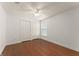Empty bedroom with wood floors, ceiling fan and a double closet at 16224 Magnolia Hill St, Clermont, FL 34714