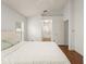Bright bedroom with vaulted ceiling, wood flooring, and doorway to Primary bath and walk-in closet at 16224 Magnolia Hill St, Clermont, FL 34714