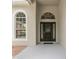 Inviting front entrance with an arched doorway, modern lighting, and a secure, stylish front door at 16224 Magnolia Hill St, Clermont, FL 34714