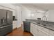 Bright kitchen features stainless steel appliances, white cabinets, granite counters, and wood floors at 16224 Magnolia Hill St, Clermont, FL 34714