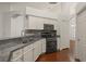 Well-appointed kitchen with stainless steel appliances, granite countertops, and white cabinetry at 16224 Magnolia Hill St, Clermont, FL 34714