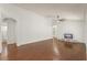Open living room boasts wood floors, fan, neutral paint, and versatile layout at 16224 Magnolia Hill St, Clermont, FL 34714