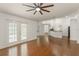 Spacious living room features wood floors, French doors, and open concept design at 16224 Magnolia Hill St, Clermont, FL 34714