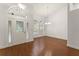 Bright living room with wood flooring, arched windows, elegant lighting, and a spacious open layout at 16224 Magnolia Hill St, Clermont, FL 34714