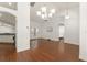 Open-concept living room boasts hardwood floors, white walls, and seamless flow to the kitchen at 16224 Magnolia Hill St, Clermont, FL 34714