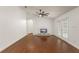 Bright, open living room featuring wood floors, ceiling fan, and access to outdoor living space at 16224 Magnolia Hill St, Clermont, FL 34714