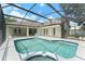 Screened pool with ample deck, blue trim, and access to the home's interior via multiple sets of French doors at 16224 Magnolia Hill St, Clermont, FL 34714