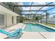 A sparkling screened in pool with a spa, lanai, and backyard is the perfect place to enjoy the Florida lifestyle at 16224 Magnolia Hill St, Clermont, FL 34714