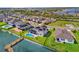 Stunning aerial view of a lakeside neighborhood, highlighting modern homes, manicured lawns, and waterfront access with private docks at 16828 Sanctuary Dr, Winter Garden, FL 34787