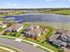 Aerial view of a residential neighborhood featuring a serene lake and well-maintained landscaping at 16828 Sanctuary Dr, Winter Garden, FL 34787
