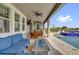 Covered back patio with a blue seating area, a table, a grill, and a swimming pool at 16828 Sanctuary Dr, Winter Garden, FL 34787