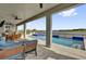 Covered patio features seating, a table, an outdoor grill, and a view of the pool and lake at 16828 Sanctuary Dr, Winter Garden, FL 34787