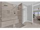 Modern shower with a glass door, tiled walls, pebble floor, and built-in bench at 16828 Sanctuary Dr, Winter Garden, FL 34787