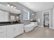 Spa-like bathroom featuring a freestanding tub, dual vanities, and elegant fixtures at 16828 Sanctuary Dr, Winter Garden, FL 34787