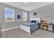 Comfortable bedroom featuring carpet floors, two windows, and space for a desk at 16828 Sanctuary Dr, Winter Garden, FL 34787