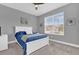 Comfortable bedroom with soft blue bedding, a white frame, and a view of the neighborhood at 16828 Sanctuary Dr, Winter Garden, FL 34787