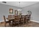 Elegant dining room with a large wooden table, chairs, chandelier, and decorative wall art, ideal for gatherings at 16828 Sanctuary Dr, Winter Garden, FL 34787