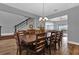 Spacious dining room featuring a long wooden table with seating for ten and an elegant chandelier at 16828 Sanctuary Dr, Winter Garden, FL 34787