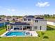 Aerial view of a modern home showcasing a private pool, patio area, solar panels, and well-maintained backyard at 16828 Sanctuary Dr, Winter Garden, FL 34787