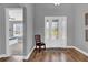 Bright foyer features wood floors, a glass-paneled front door, and a glimpse into a bedroom at 16828 Sanctuary Dr, Winter Garden, FL 34787