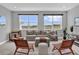 Comfortable living room with neutral tones, large windows, and modern furnishings for a relaxing atmosphere at 16828 Sanctuary Dr, Winter Garden, FL 34787