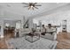 Open-concept living space with modern furnishings, hardwood floors, seamlessly connecting living room and kitchen at 16828 Sanctuary Dr, Winter Garden, FL 34787