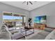 Open concept living room with sliding glass doors to outdoor kitchen and scenic lake view at 16828 Sanctuary Dr, Winter Garden, FL 34787