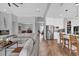 Open-concept living space with modern furnishings, hardwood floors, seamlessly connecting living room and kitchen at 16828 Sanctuary Dr, Winter Garden, FL 34787