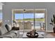 Living room view to covered patio with outdoor kitchen overlooking pool and scenic lake at 16828 Sanctuary Dr, Winter Garden, FL 34787