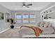 Inviting main bedroom with water views, neutral tones, and a ceiling fan for added comfort at 16828 Sanctuary Dr, Winter Garden, FL 34787
