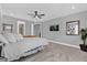 Calm main bedroom featuring soft lighting, a ceiling fan, and an en-suite bathroom at 16828 Sanctuary Dr, Winter Garden, FL 34787
