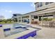 Stunning outdoor pool with a swim-up bar and seating, covered patio, and lush landscaping for resort-style living at 16828 Sanctuary Dr, Winter Garden, FL 34787