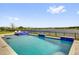 Beautiful pool with lake view featuring sun shelf and integrated spa, ideal for relaxation and outdoor enjoyment at 16828 Sanctuary Dr, Winter Garden, FL 34787