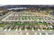 Expansive aerial view showcases a residential neighborhood near a tranquil lake and lush greenery at 2024 Griffin Oaks Way, Tavares, FL 32778