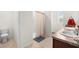 Bright bathroom boasts a double sink vanity and a shower with a neutral shower curtain at 2024 Griffin Oaks Way, Tavares, FL 32778