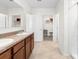 Bathroom featuring double sinks, warm cabinets, and a shower at 2024 Griffin Oaks Way, Tavares, FL 32778