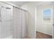 Tiled shower with glass enclosure next to doorway at 2024 Griffin Oaks Way, Tavares, FL 32778