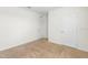 Bright bedroom with neutral carpet, white walls, and two doors at 2024 Griffin Oaks Way, Tavares, FL 32778