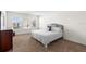 This main bedroom has neutral carpets, a queen bed, and nice view at 2024 Griffin Oaks Way, Tavares, FL 32778