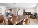 Open concept dining area with ample seating flows into living room and kitchen at 2024 Griffin Oaks Way, Tavares, FL 32778