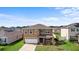 Two-story home featuring a manicured lawn, attached garage, and modern architectural details at 2024 Griffin Oaks Way, Tavares, FL 32778