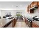 Open kitchen with an island, stainless steel appliances, and a view of the living area at 2024 Griffin Oaks Way, Tavares, FL 32778